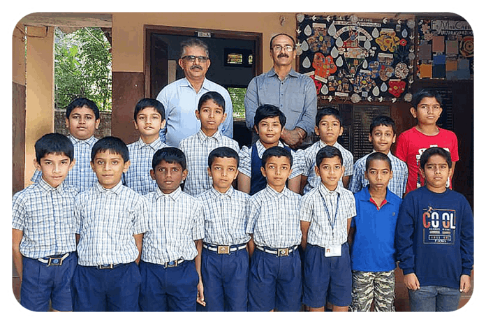 Children from KESST's Sainik School Entrance Examination Coaching Class with Trustees Marchanda Ganesh Ponnappa and Pattada Dhanu Uthaiah.