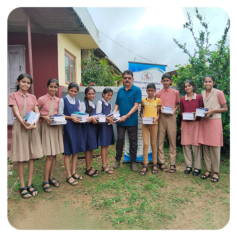 KESST  |  Mr Marchanda Ganesh Ponnappa, Secretary KESST, distributes free note books to beneficiaries at Triveni School, Virajpet, Kodagu.